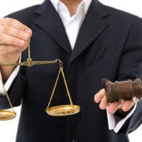 lawyer holding scales and gravel