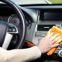 claning car dashboard with a microfiber cloth