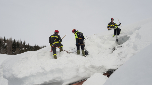 professional snow cleaners remove snow from roof