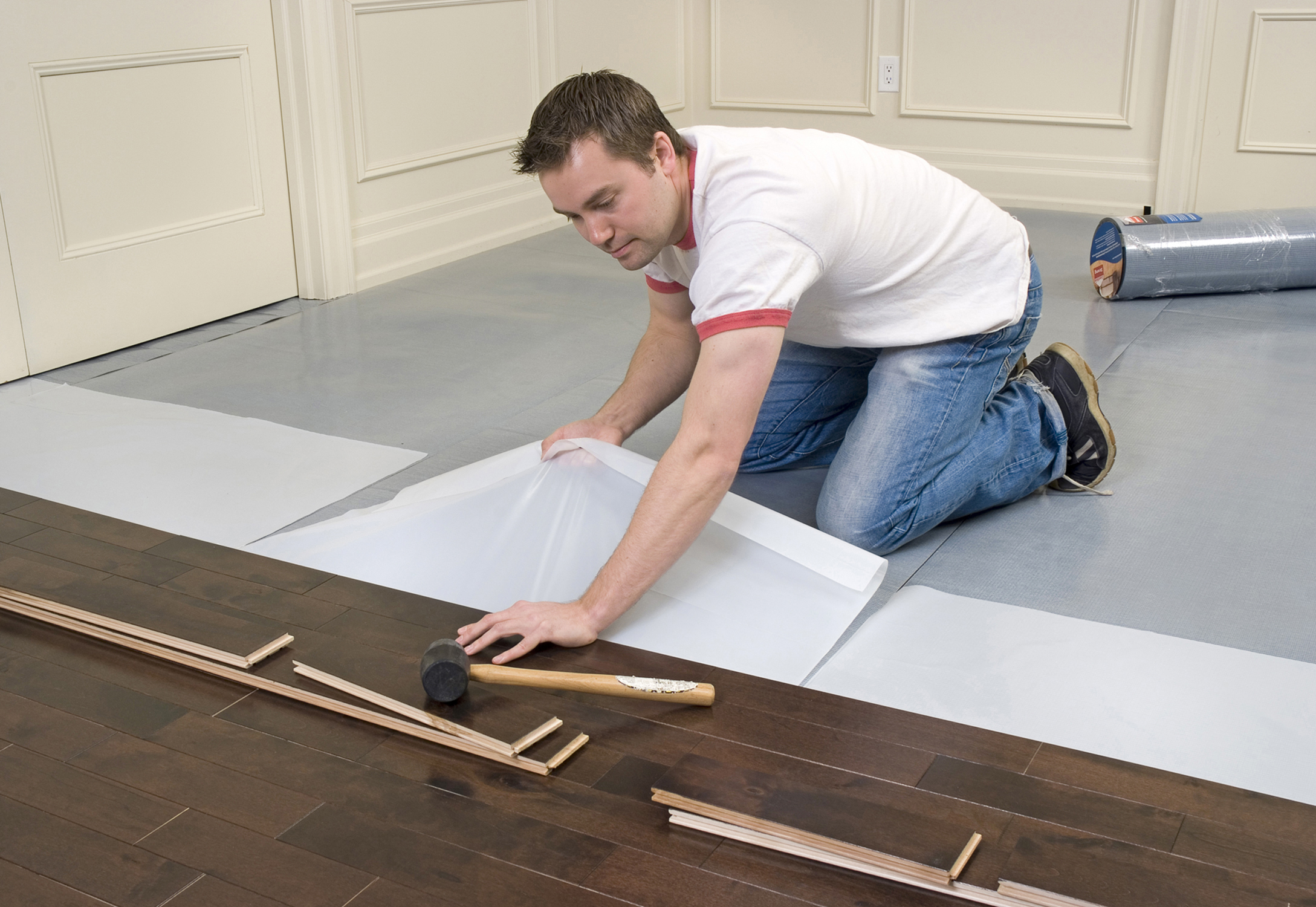 man installing dark laminate