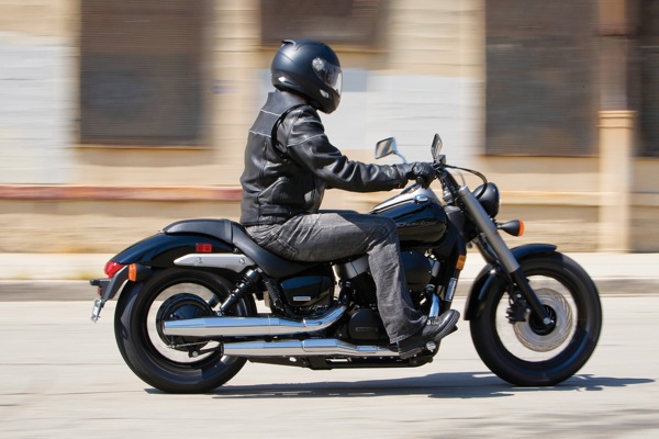 man in helmet riding a black motorcycle