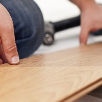 man laying laminate flooring