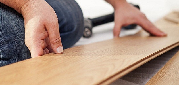 man laying laminate flooring