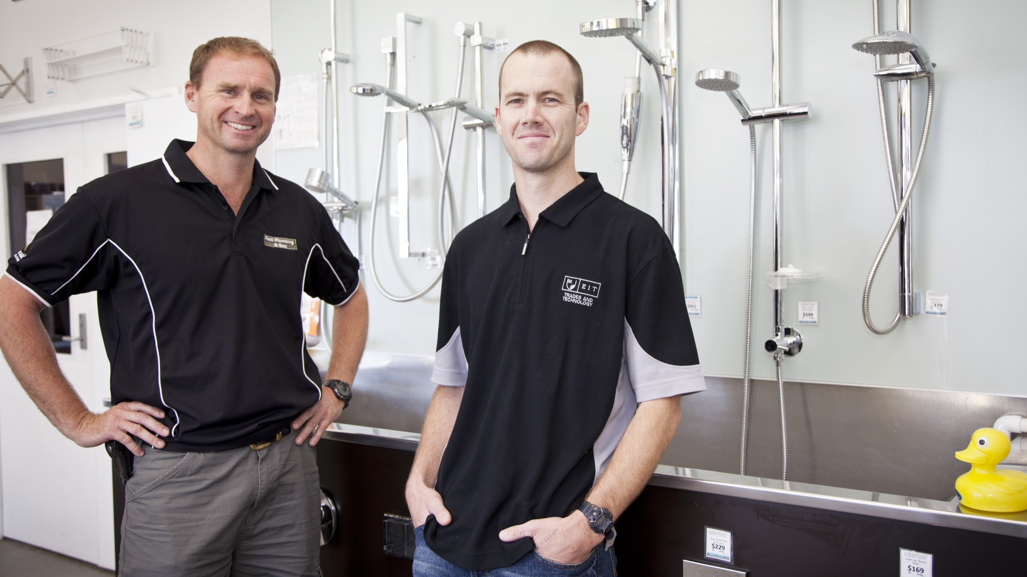 two plumbers in black t-shirts