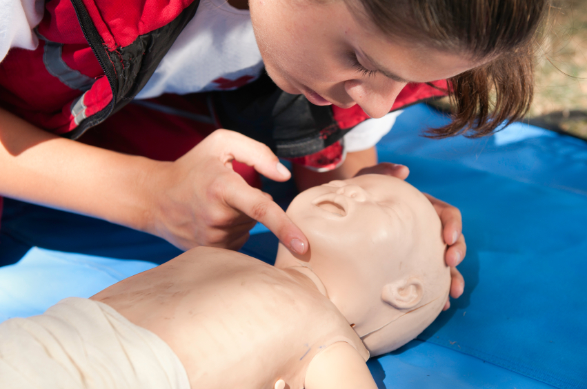 woman frist aid training on a baby robot