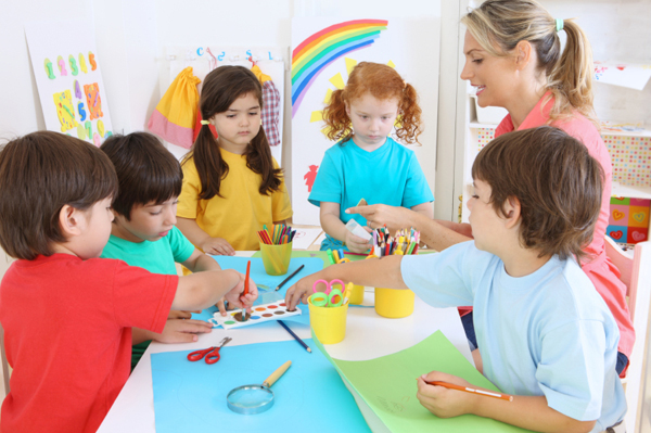 daycare teacher crafting with children