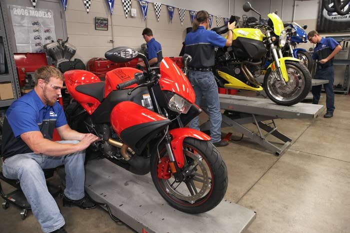 motorcycles and mechanics at a repair shop