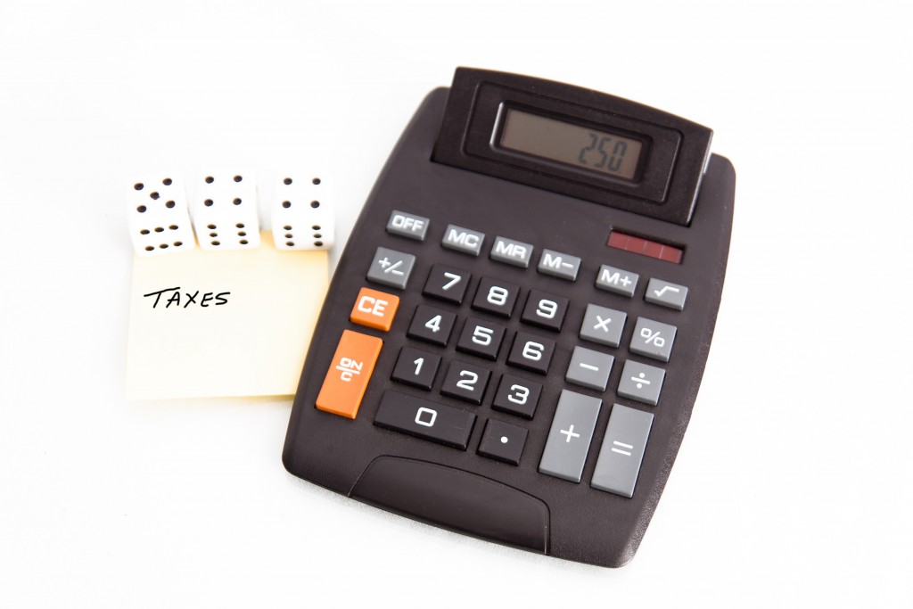 Tax concept with calculator, note, dice.