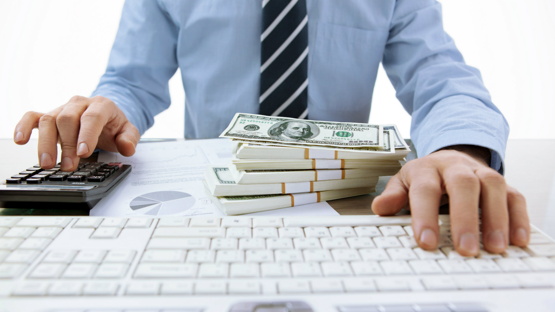 accountant in front of computer with money