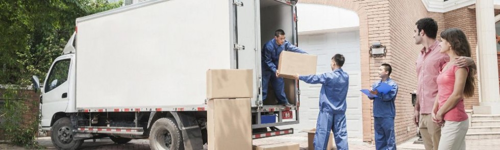 movers loading a truck and clients watching them