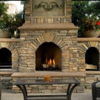 outdoor fireplace on patio with chairs and coffee table
