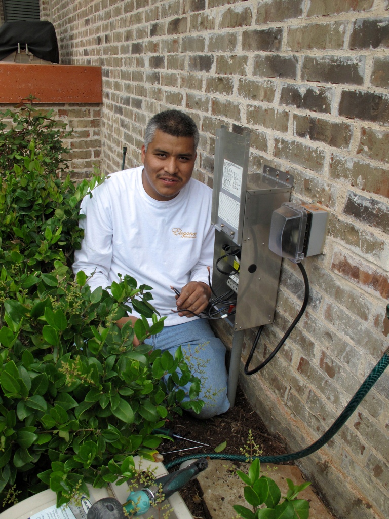 electrician installing outlet for landscaping lights