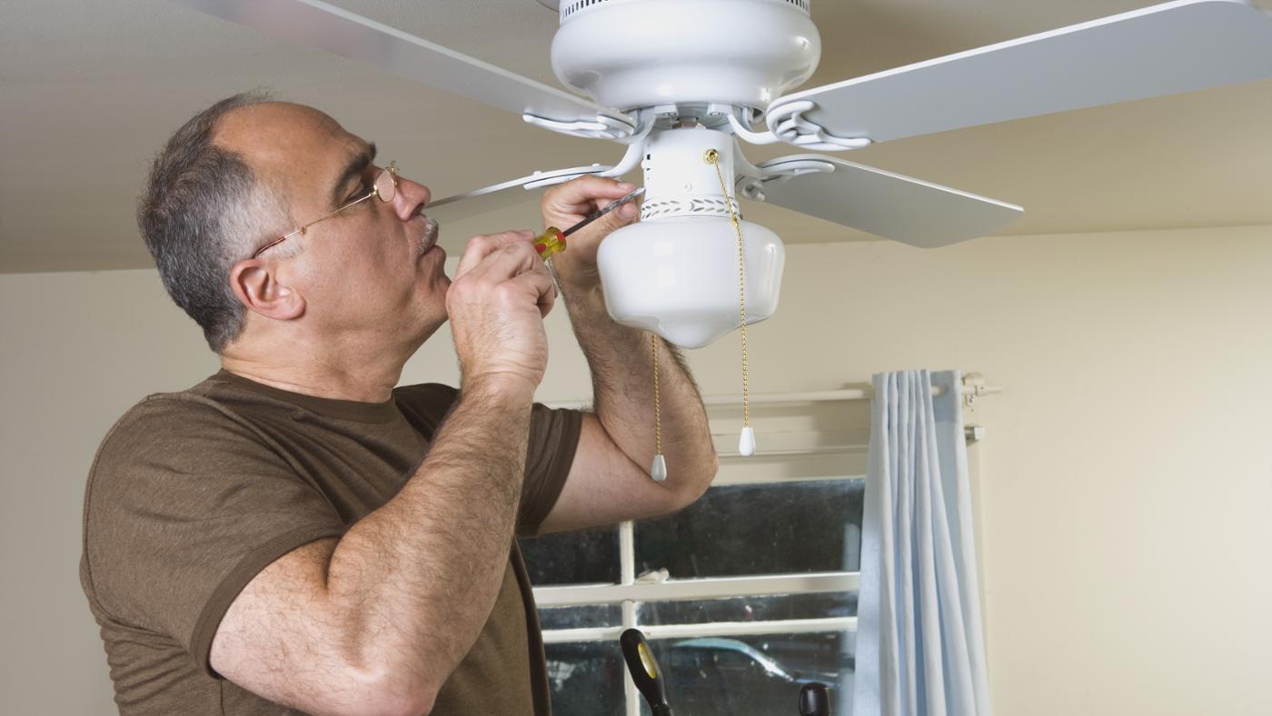 electrician installing a ceiling fan