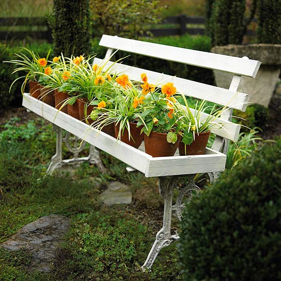 white bench platner with flowers in pots garden decor