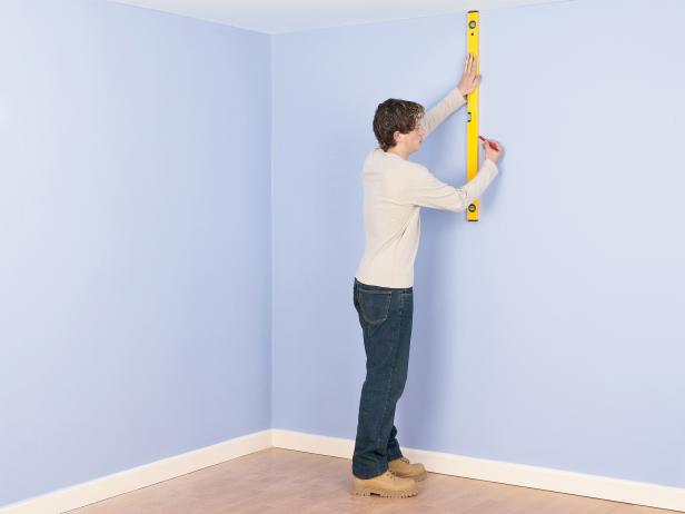 man measuring the wall