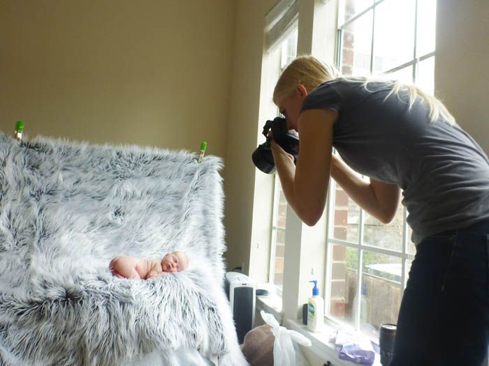 photographer taking pictures of a newborn baby