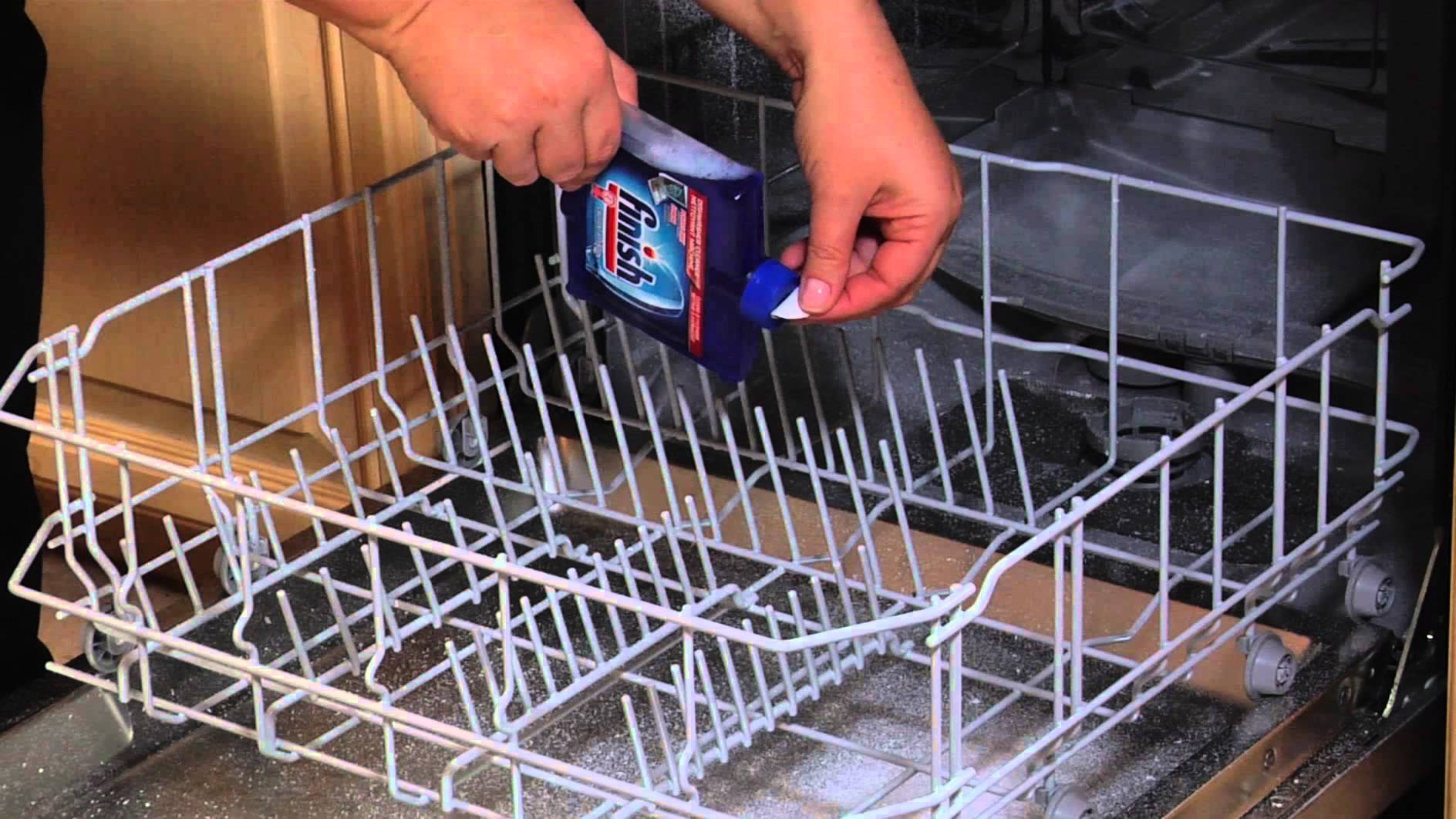 man placing s dishwasher cleanser inside the machine