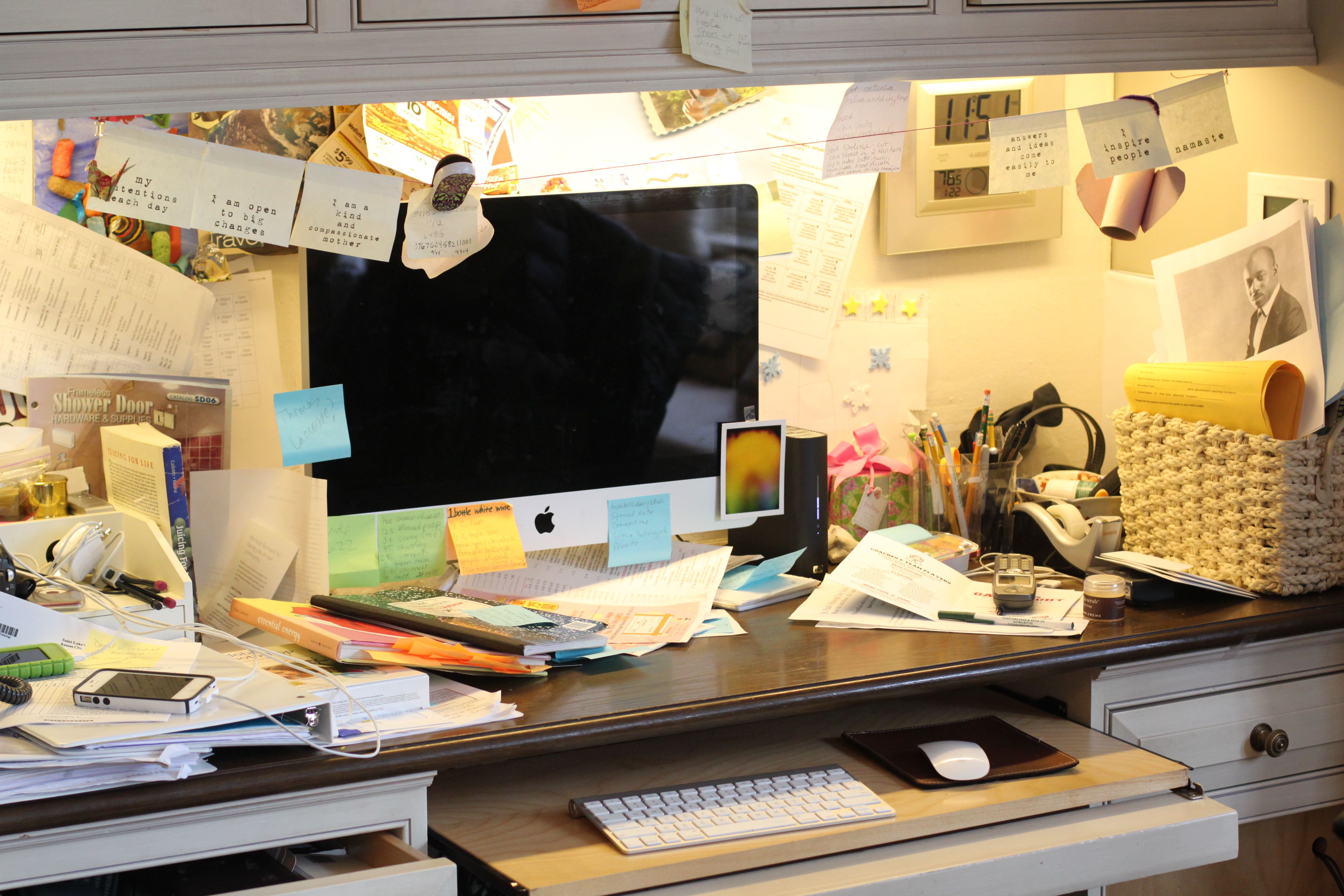 extremely cluttered office desk