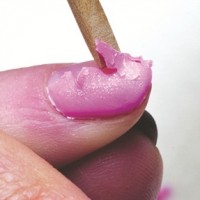 removing gel polish with a wooden stick