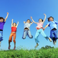 kids jumping in summertime