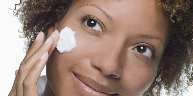 woman moisturizing her face skin