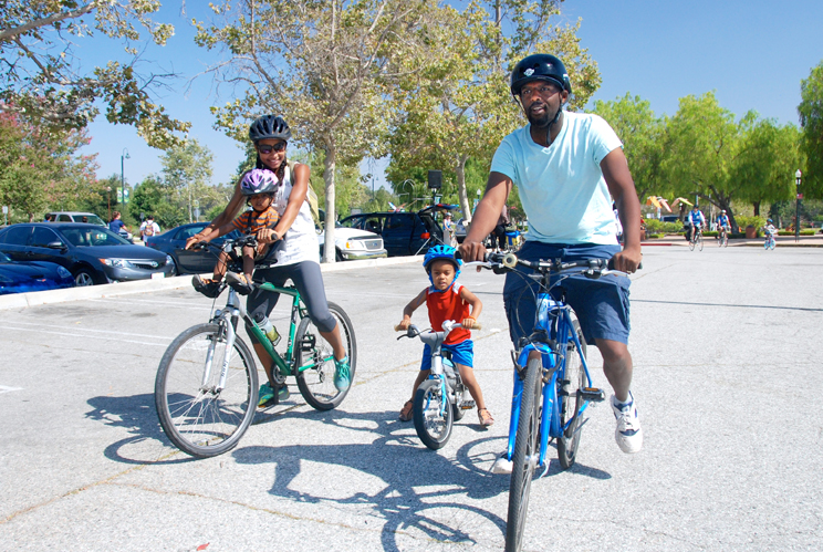parents biking with 2 small kids