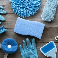 House cleaning product on wood table, blue equipment concept