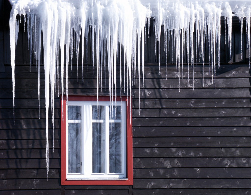 Many icicles hang on chalet´s roof