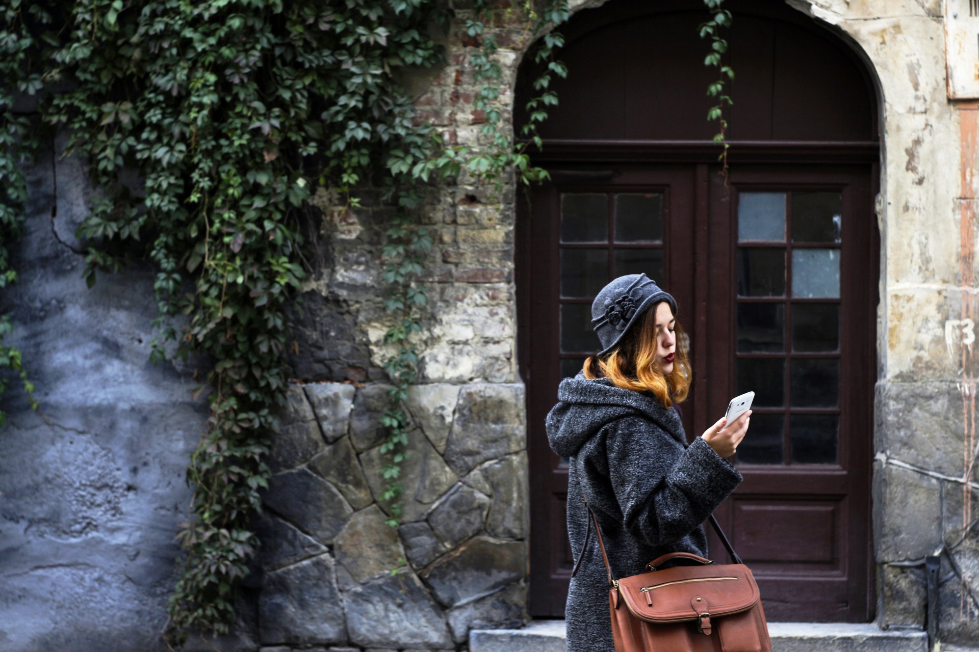 woman at the doorstep using gadget for senios