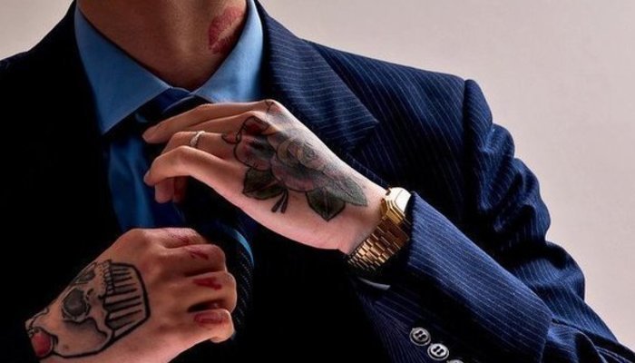 man in suit with tattoo