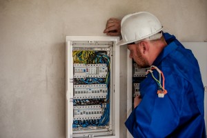 electrician inspecting a panel