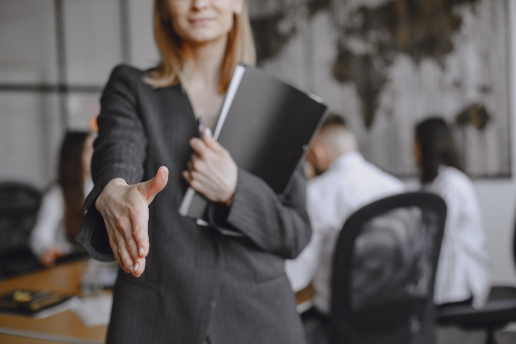 girl-signs-documents-lady-sitting-table-manager-working-office
